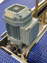 Electric motors in the stainless steel conveyor system with polyurethane, modular belt. Transport...