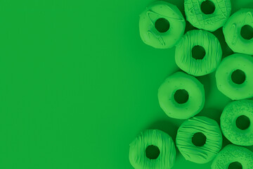 Isometric view of glazed donut with sprinkles on plain monochrome green color
