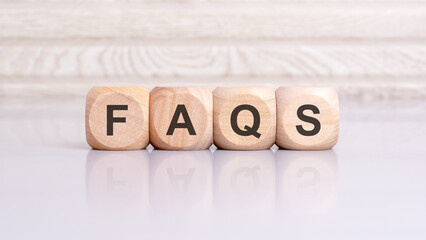 wooden cubes with letters form the expression Faqs