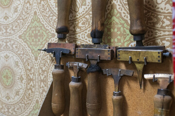 Antique tools hung on a wooden wall