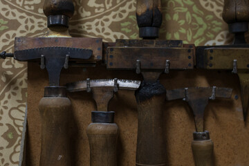Antique tools hung on a wooden wall