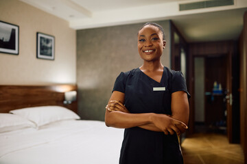 Portrait of confident black maid in  hotel looking at camera.