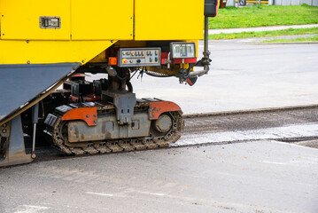 Road work resurfacing repairs. Road milling machine removing old pavement.