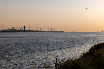 Beautiful windmills in the port of Rotterdam. Beautiful sunset on the sea coast. The Blue North Sea...