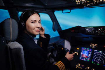 A female pilot controls a large passenger plane