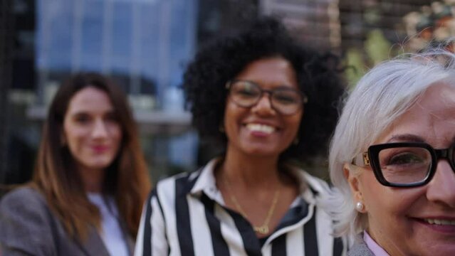 Formal work group of smiling happy diverse business only women standing in a row looking cheerful to camera together proud expression outdoor. Professional empowered females leaders posing confidence