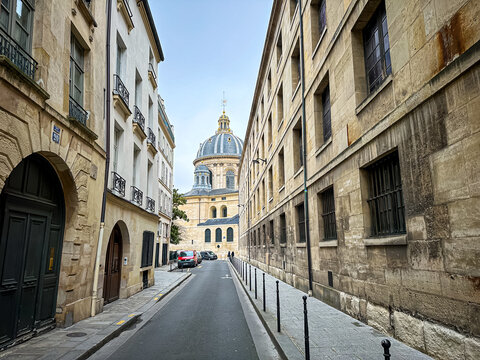 Paris, France - 20.02.2024. View from Rue de Seine towards Institut de France, Paris. Grand cupola-topped building in baroque style, the headquarters of 5 French intellectual academies. The famous Ins