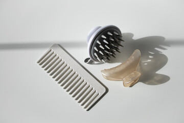 Hair comb, scalp massager and hair clip on white background