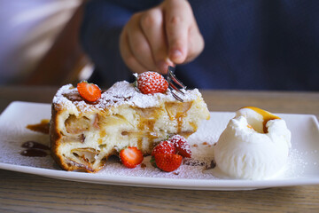 Person Cutting Into Dessert on Plate