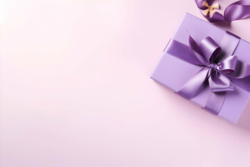 Gift box with purple ribbon and bow on pink background. copy space