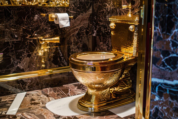 Luxurious Golden Toilet in a Lavish Marble Bathroom