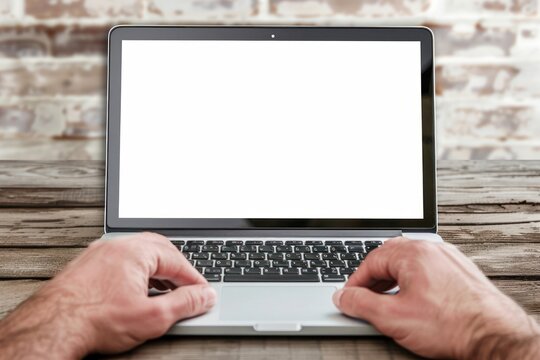 Close-up of male hands and laptop with blank screen