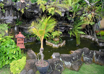 Balinese Grotto Garden with Pond and Lamp and Palm and Ferns