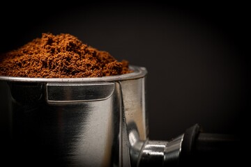 freshly ground coffee powder in the portafilter for machine
