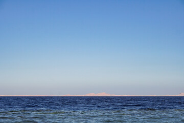 Red sea in Egypt and Tiran island (Saudi Arabia) arid mountains in the distance