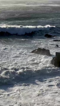 Pacific ocean waves rolling on the rocky shore