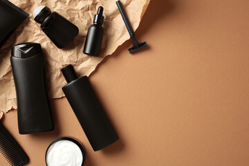 Flat lay composition with men's cosmetic products on craft paper on brown background. Beauty...