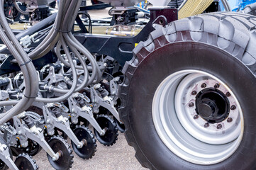 Detailed close-up image showing the tires and complex suspension system of heavy-duty machinery.