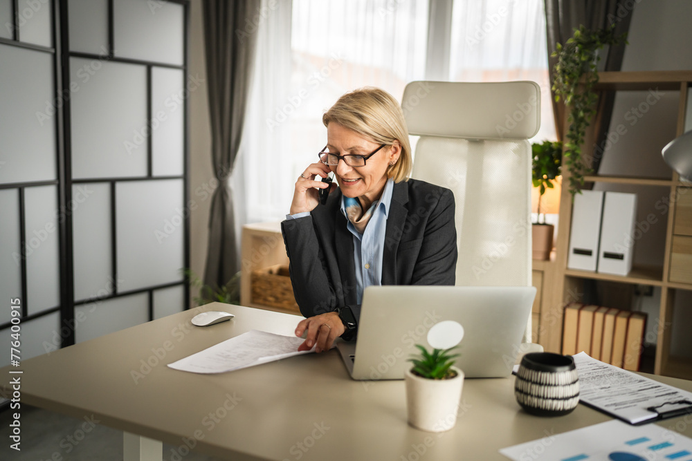 Wall mural Mature woman business make a phone call at work talk happy smile