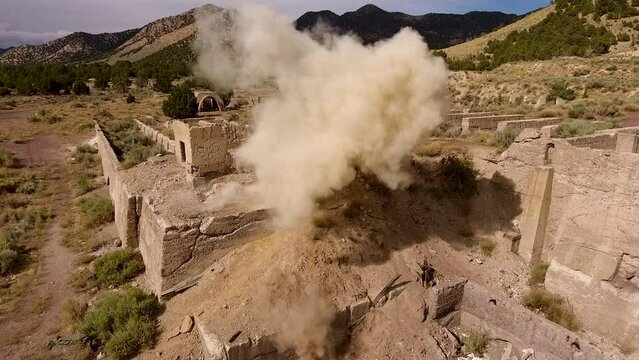 Gunman shooting on ruins and exploding - epic drone shot