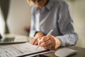 Mature woman businesswoman sign document contract at office at work