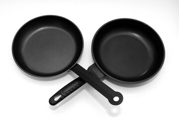 Empty black non stick stainless steel frying pans isolated on white  - 776419731