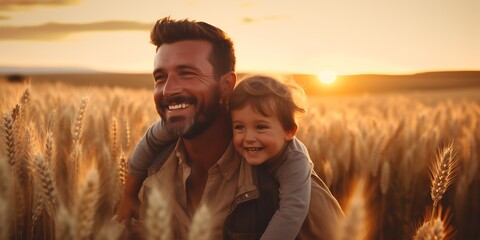 Happy father and son in wheat field at sunset. Happy family concept.