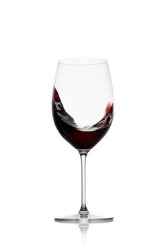 Red wine in a glass with splash isolated on white background