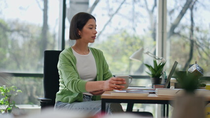 Businesswoman taking espresso sip office work break. Dreamy girl drinking coffee