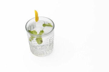 High-angle view of a cocktail with mint and ice in a glass, isolated on a white backdrop