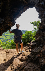 Female Hiker in Cave Opening on The Sleeping Giant Trail, Kapa'a, Kauai, Hawaii, USA