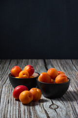 Juicy apricots on black background.