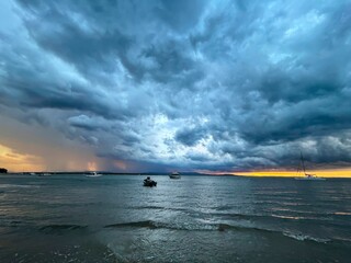 Storm out at sea with boats during sunset, Seventeen Seventy, Queensland, Australia