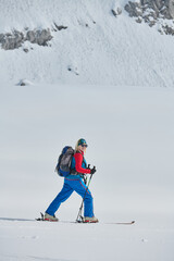 A Female Mountaineer Ascends the Alps with Backcountry Gear - 776498327