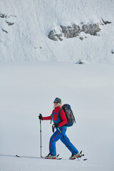 A Female Mountaineer Ascends the Alps with Backcountry Gear - 776498755