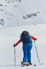 A Female Mountaineer Ascends the Alps with Backcountry Gear - 776500105