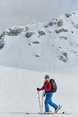 A Female Mountaineer Ascends the Alps with Backcountry Gear - 776500729