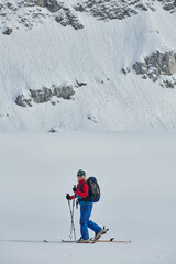 A Female Mountaineer Ascends the Alps with Backcountry Gear - 776501545