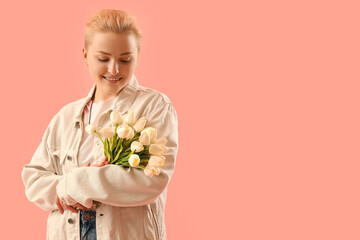 Young woman with tulips on pink background