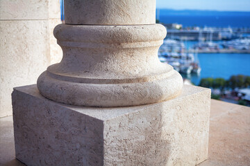 Detail of a stone column in the port. Stone column carving adds elegance to the architectural ensemble 