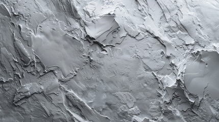 A grey and white image of a rocky surface with a few small patches of color. The image has a moody and desolate feel to it, with the grey and white tones dominating the scene& White cement wall in ret