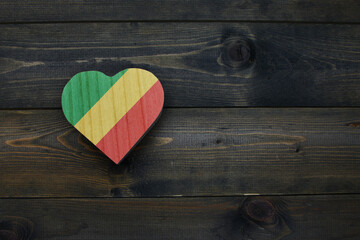 wooden heart with national flag of republic of the congo on the wooden background.