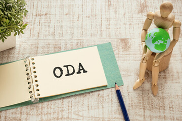 There is notebook with the word ODA. It is an abbreviation for Official Development Assistance as...