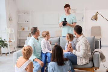Male photographer working with big family in studio