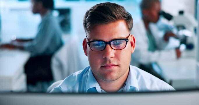 Science, research and man at computer thinking, reading and checking results in pharmaceutical study. Glasses, reflection and person on website for medical review, report or typing lab ideas at desk
