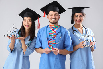 Medical graduate students with DNA and molecular models on white background
