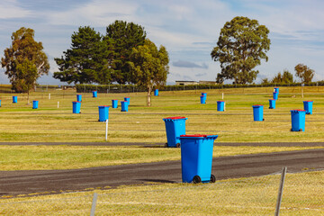 Blue wheelie rubbish bins dotted throughout grounds of Mount Panorama - obrazy, fototapety, plakaty