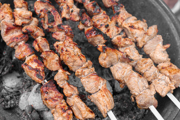 Cooking delicious kebab on metal brazier, above view