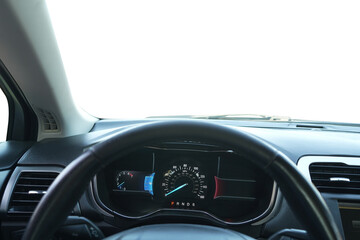 Speedometer on dashboard and steering wheel inside car