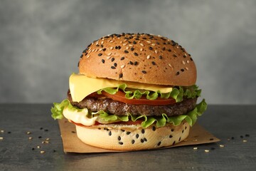 Burger with delicious patty on gray table